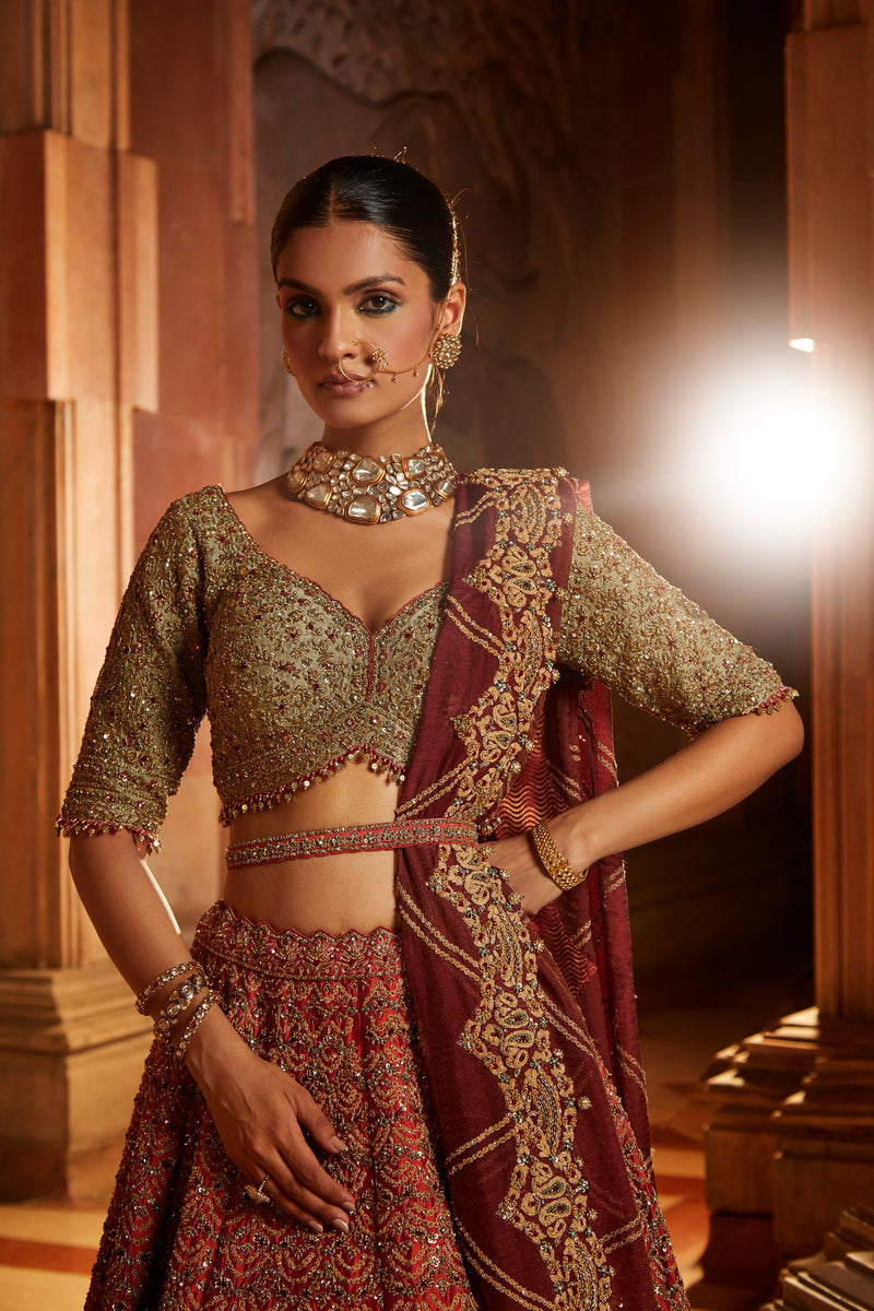 RUST TAFETTA LEHENGA WITH OLIVE CHOLI, MAROON TISSUE DUPATTA AND BELT