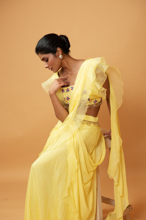 YELLOW RUFFLE SAREE WITH LACE.