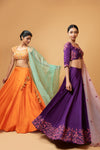 BRIGHT ORANGE LEHENGA WITH INTRICATE HANDWORK .