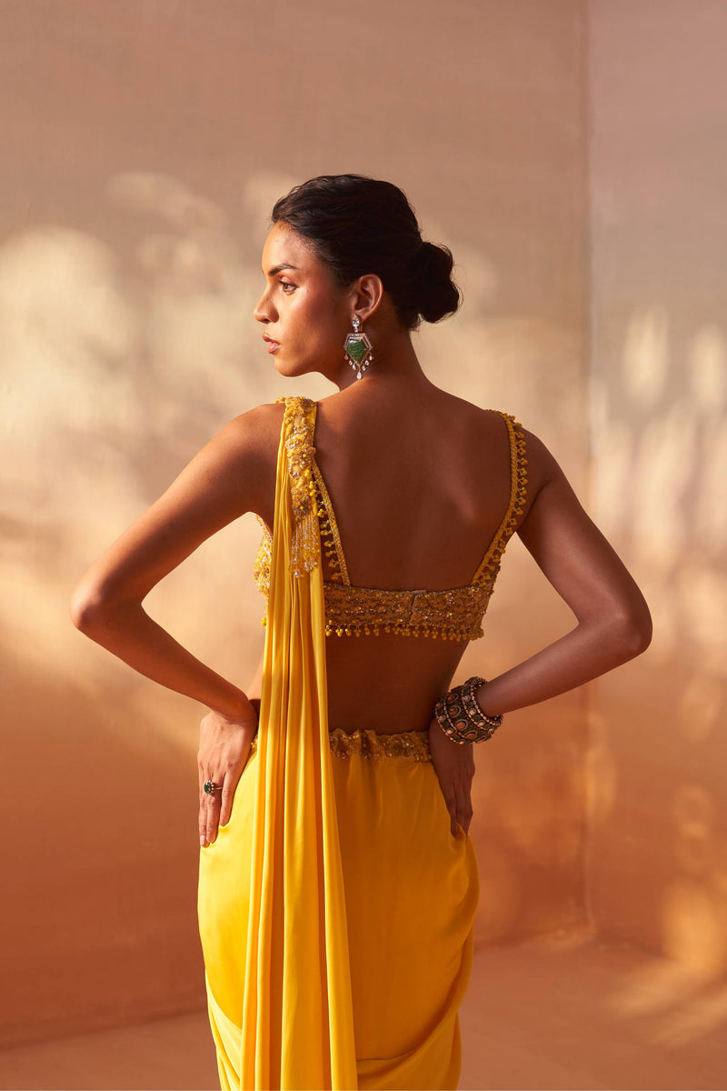 YELLOW DRAPED SAREE WITH NUDE CHOLI