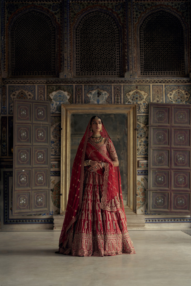 DEEP RED RAW SILK LEHENGA CHOLI SET WITH A TULLE DUPATTA AND AN OPTIONAL SECOND DUPATTA AND BELT.