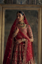 DEEP RED RAW SILK LEHENGA CHOLI SET WITH A TULLE DUPATTA AND AN OPTIONAL SECOND DUPATTA AND BELT.