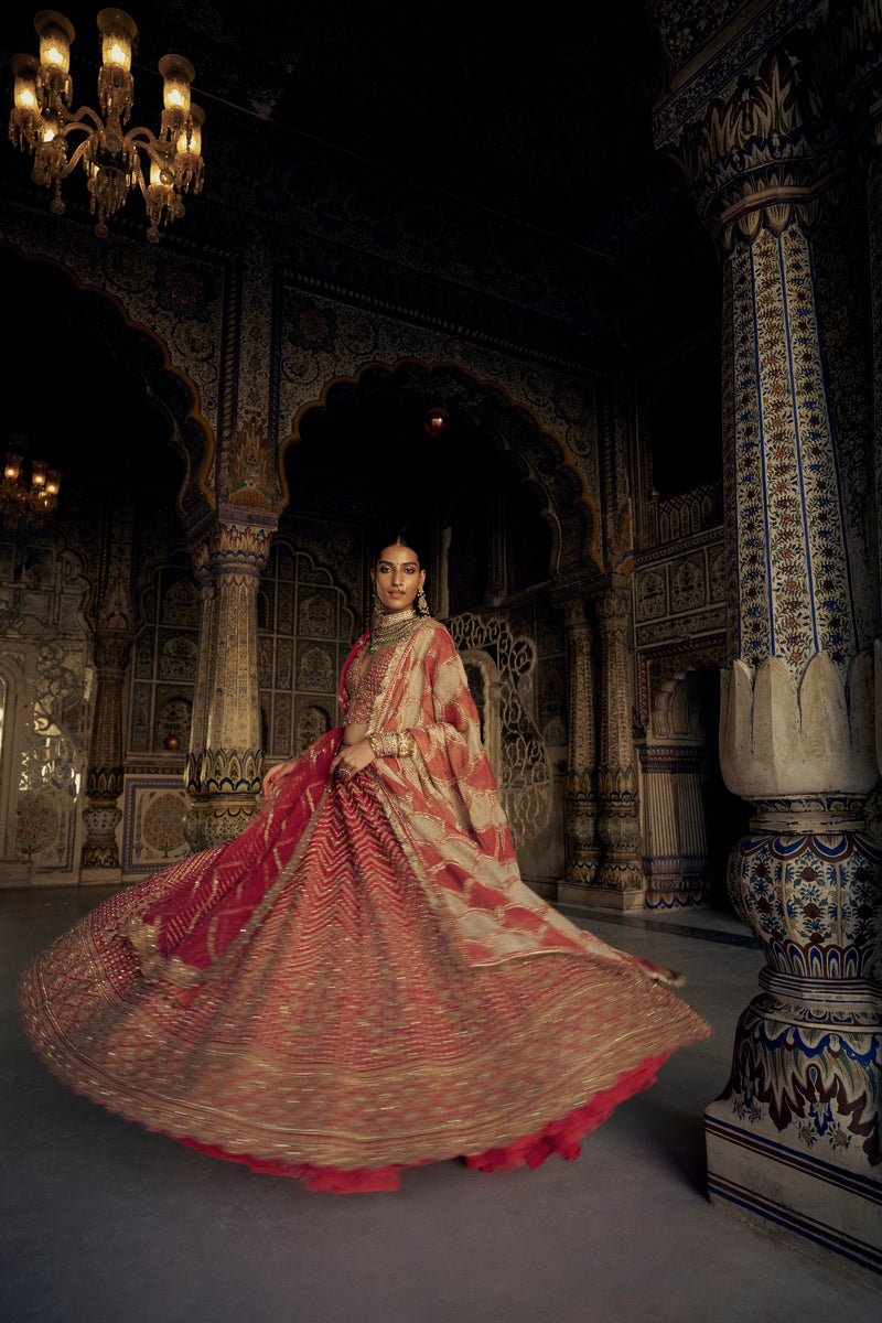 RED RAW SILK LEHENGA CHOLI WITH A NET DUPATTA