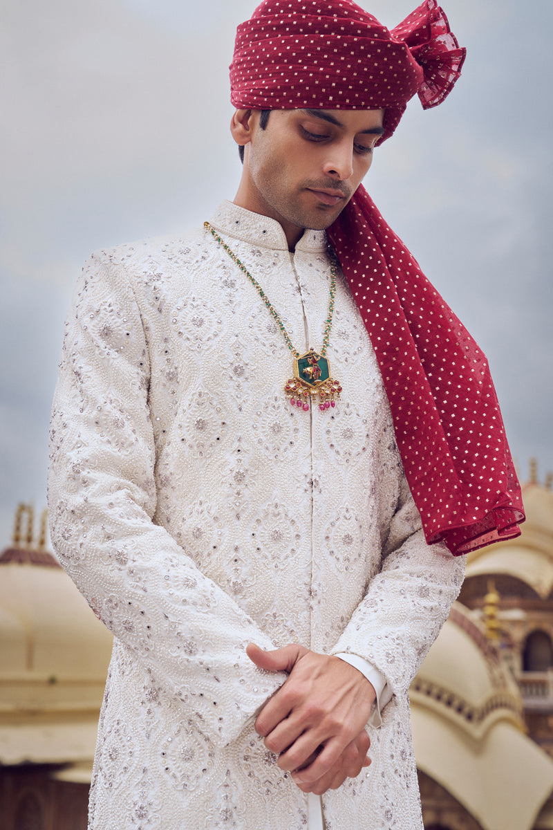 IVORY RAW SILK SHERWANI WITH A COTTON SILK CHOGA AND CHURIDAR