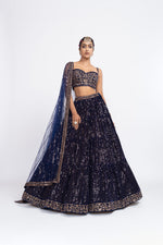 Navy blue corset blouse paired with dense dot lehenga.