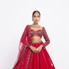 Red double-tier lehenga set with sweetheart neck and heavy full-sleeve blouse.