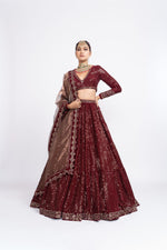 Mehroon dense dot full sleeve blouse paired up with dense dot lehenga.