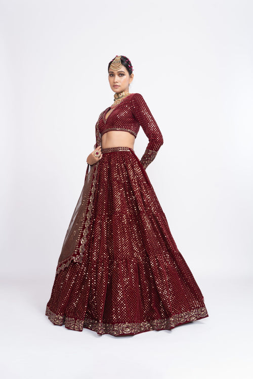 Mehroon dense dot full sleeve blouse paired up with dense dot lehenga.