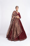 Mehroon dense dot full sleeve blouse paired up with dense dot lehenga.