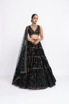 Deep green full-tier linear lehenga set without sleeve blouse.