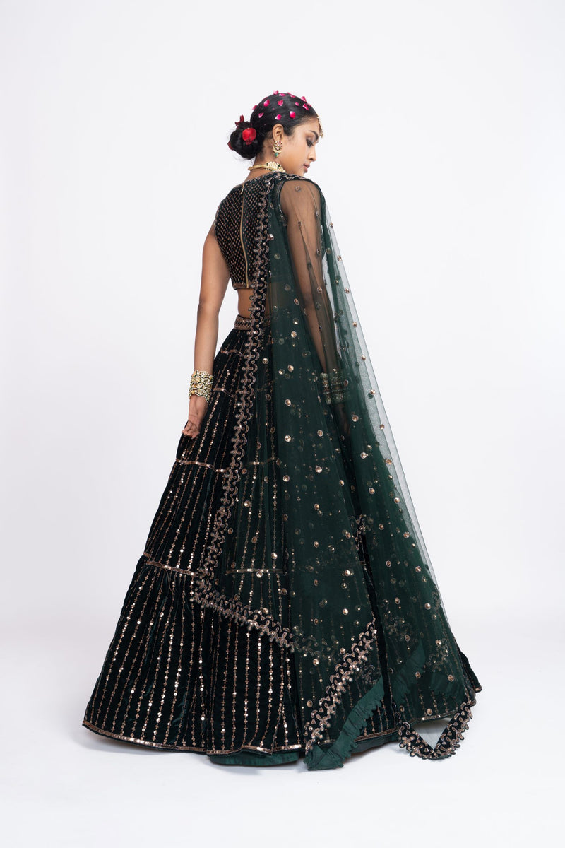 Deep green full-tier linear lehenga set without sleeve blouse.