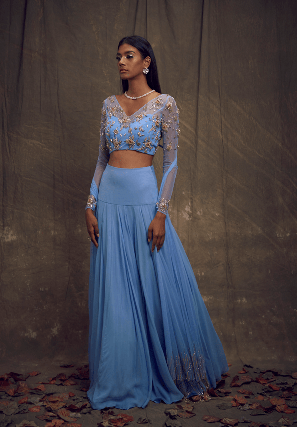 Light blue embellshed full sleeves blouse with long attached net drapes + wide waistband skirt
